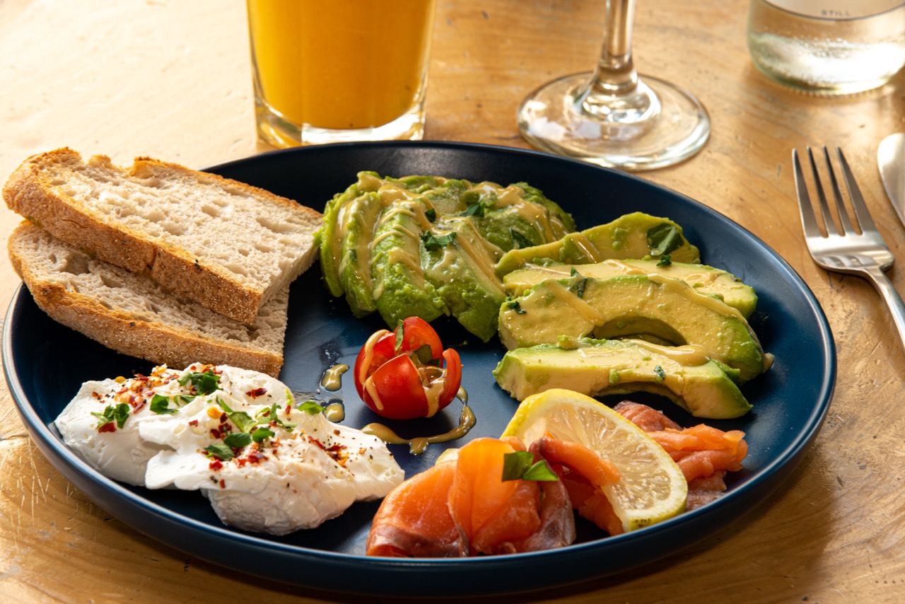 Avocado breakfast plate with salmon and poached eggs