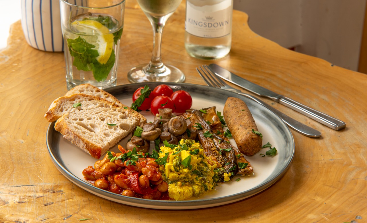 Full English breakfast with eggs, beans, and mushrooms