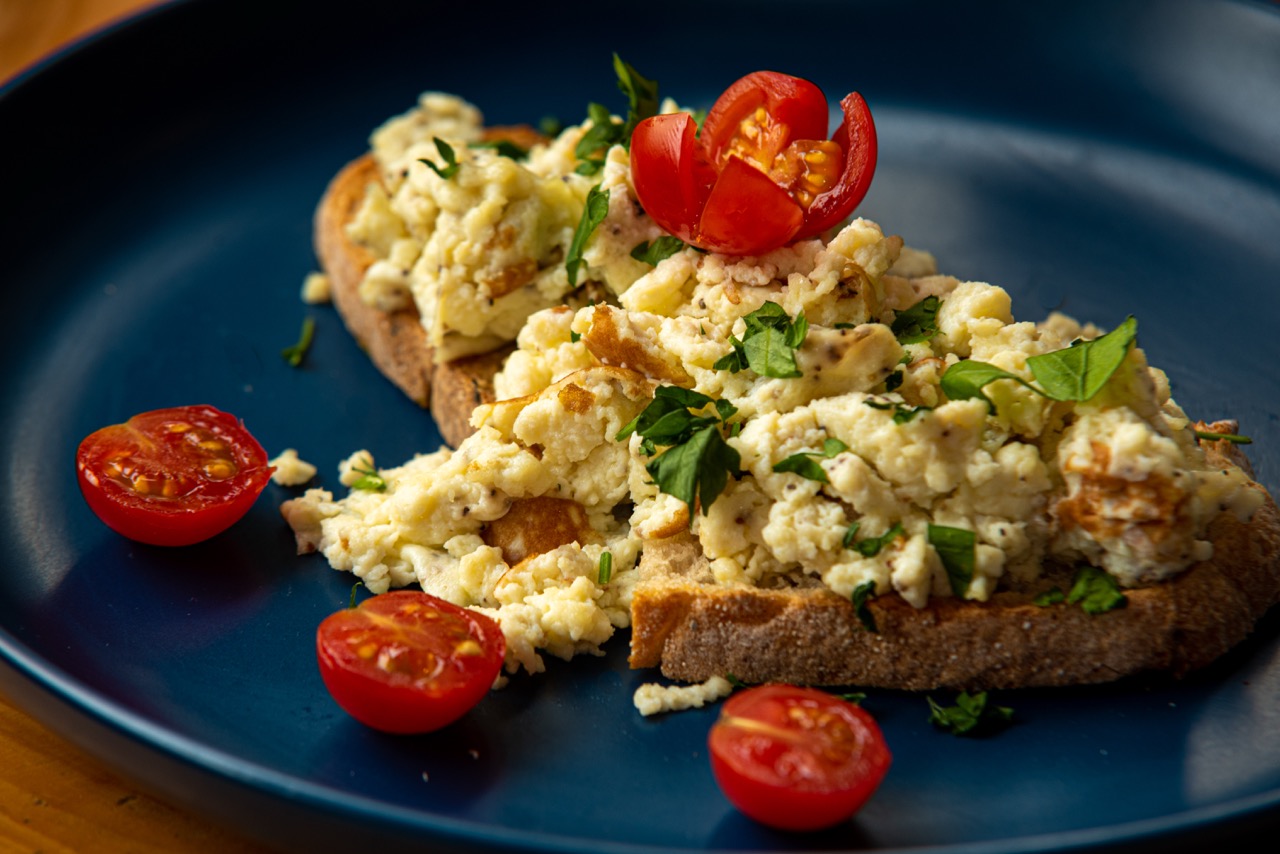 Scrambled eggs on toast with cherry tomatoes